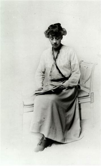 Photograph 
      of Violet Needham as an adult, posed reading